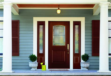 blue front door with sidelights.